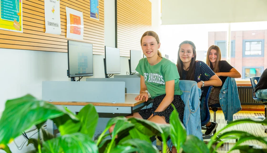3 scholieren achter computers
